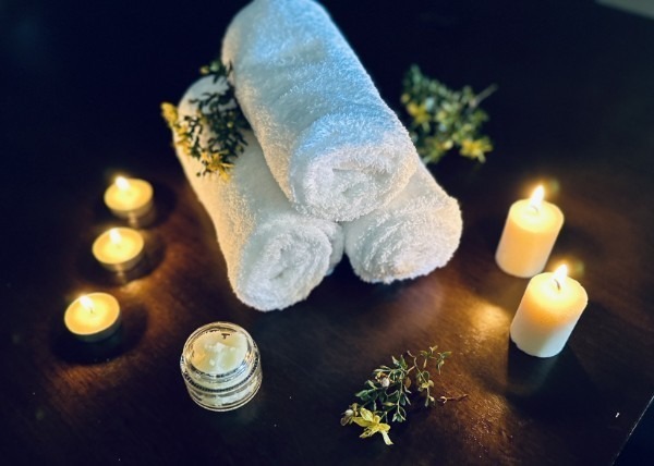Luxury mobile spa setup with plush towels and candles